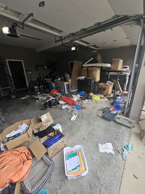Cluttered garage before a full junk removal cleanout