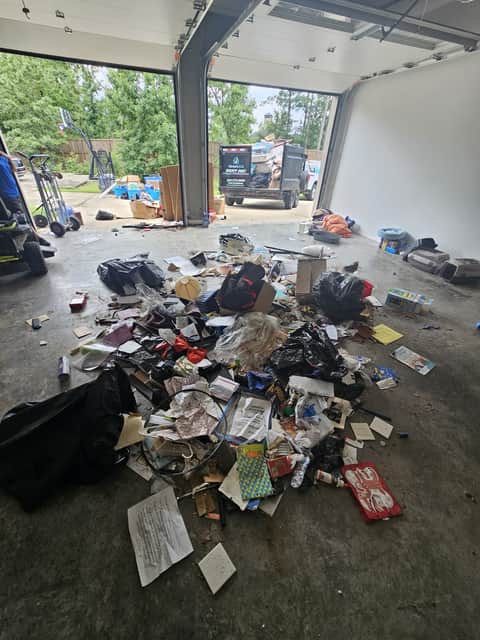 Garage cleanout in progress with the Xenya's LLC dump trailer outside