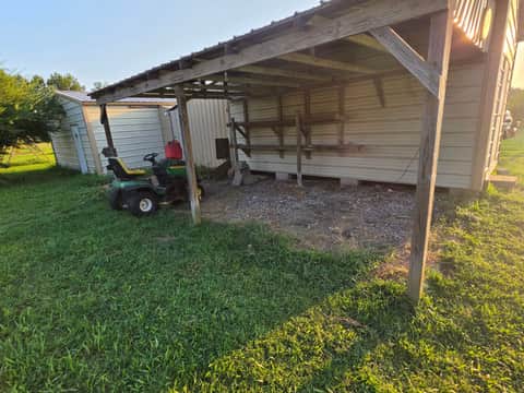 Same backyard shed area fully cleared and cleaned after junk removal